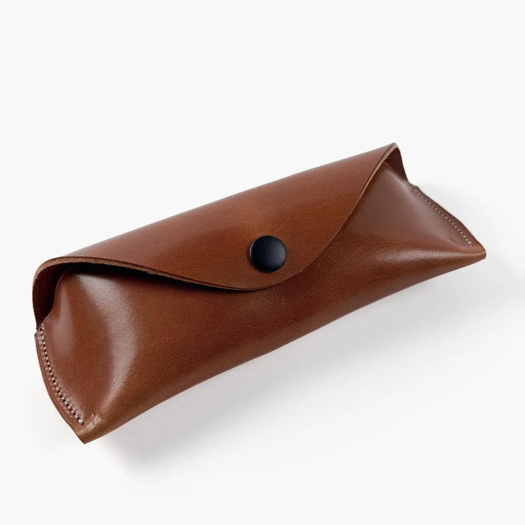 Brown Harness Sunglasses Case - handmade Wickett & Craig leather, closed, with the popper fastened